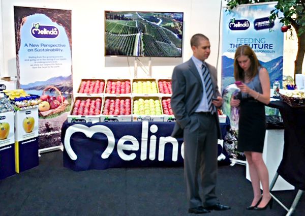 Melinda Apples at ICA: Italian apple display with fresh produce and promotional banners. Trade show exhibit.