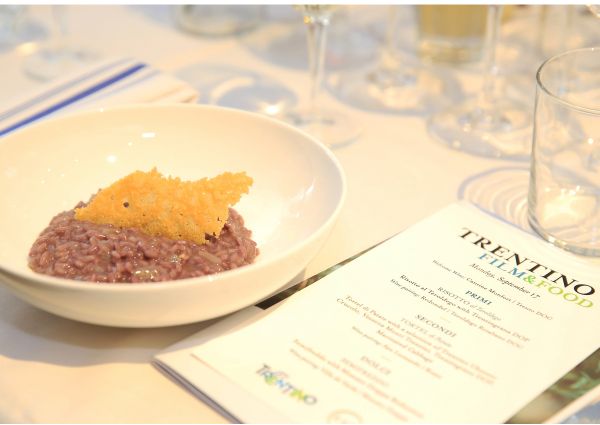 Trentino food at Eataly. Risotto al Teroldego with cheese crisp. Italian cuisine.