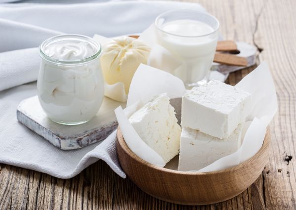 dairies-Organic dairy products on rustic wooden table. Cheese, milk, butter, sour cream