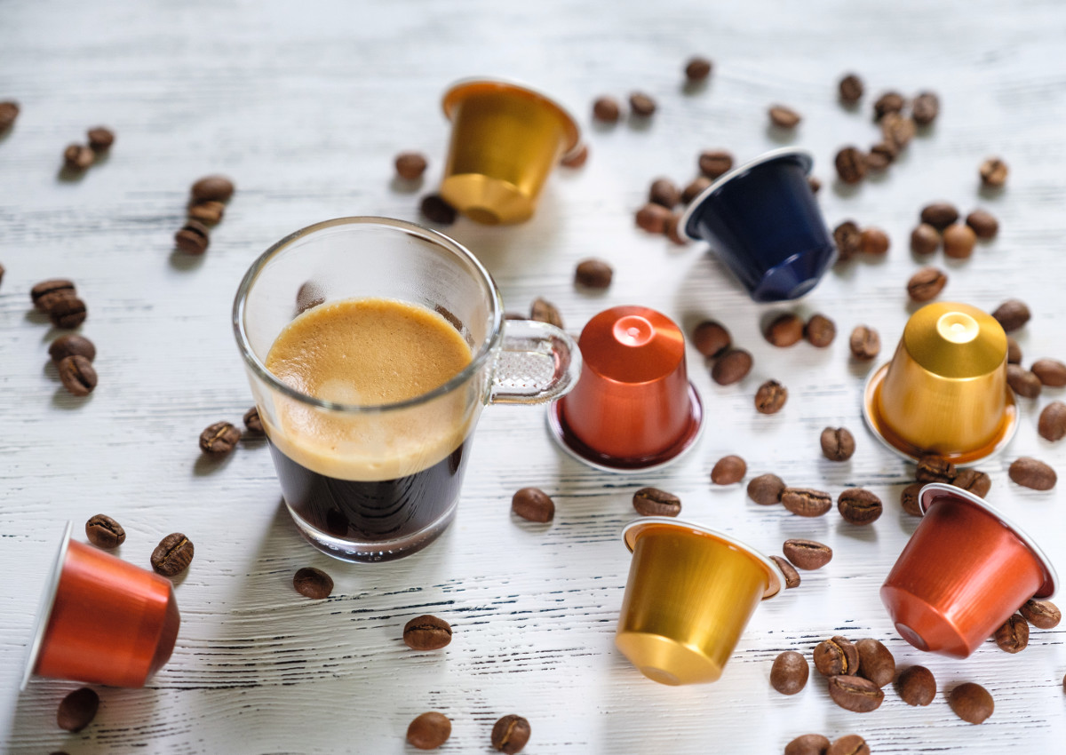 Cup of espresso with coffee beans and capsules-beer