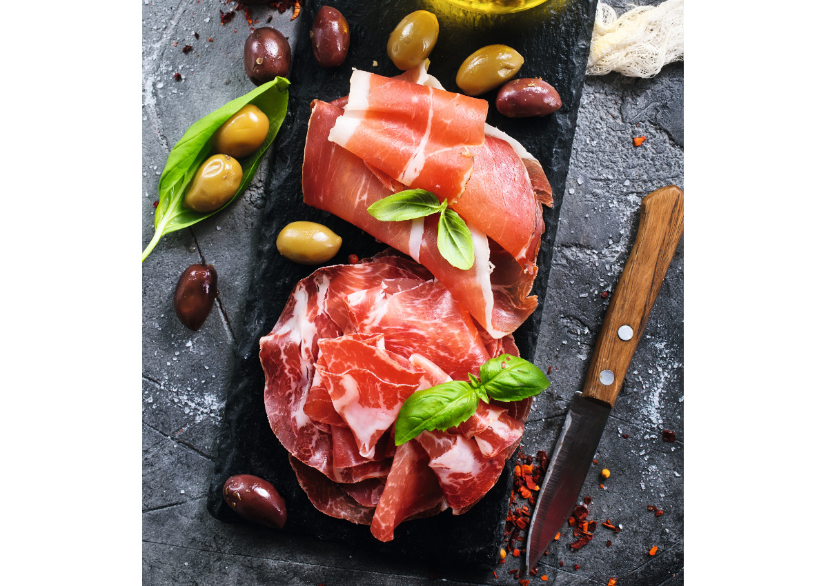 deli meats-prosciutto with olives and spice on a table