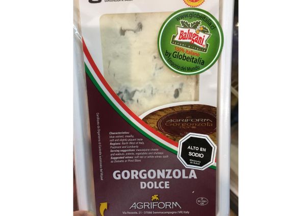 Italian Gorgonzola Dolce cheese in packaging. Creamy, blue-veined cheese product.