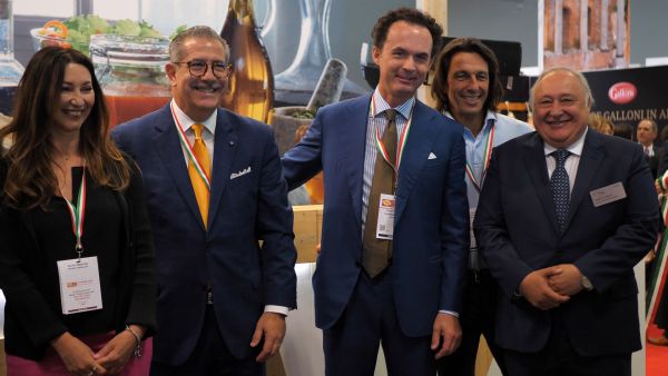 Italian Food Awards USA 2019 winners. Group of people at the awards ceremony wearing Italian flag ribbons.