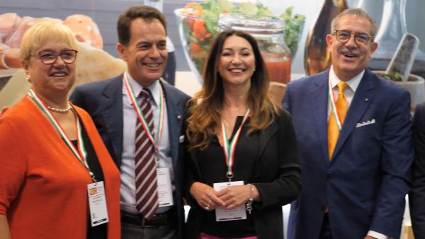 Italian Food Awards USA 2019 winners. Group portrait of smiling people with Italian flag ribbons.