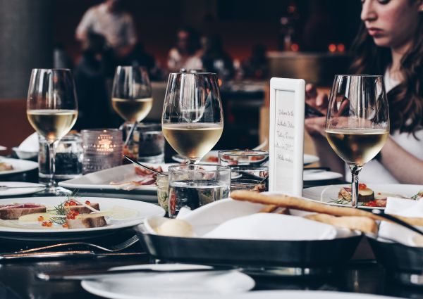 Authentic Italian Table: Wine glasses and appetizers on a beautifully set table at a restaurant.