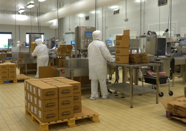 Veroni USA food production facility. Workers in clean suits pack Veroni charcuterie products.