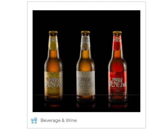 Three bottles of Birra Venezia, Italian beer. Gold, silver, and red labels.