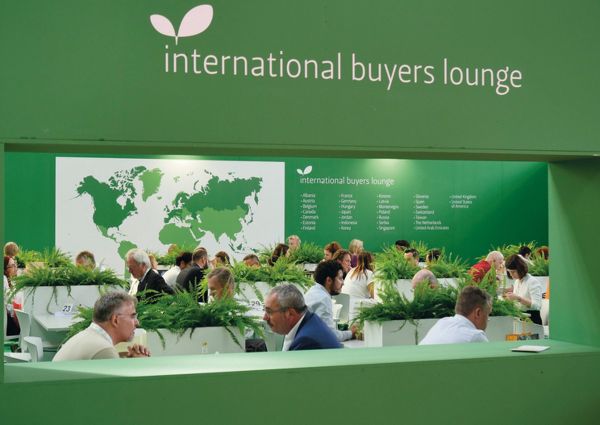 SANA organic market: International buyers lounge with world map backdrop. Business networking at trade show.