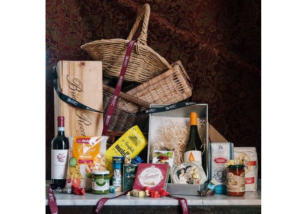 Enoteca Sileno Italian hamper. Wine, pasta, pesto, and other gourmet Italian food products in a basket.
