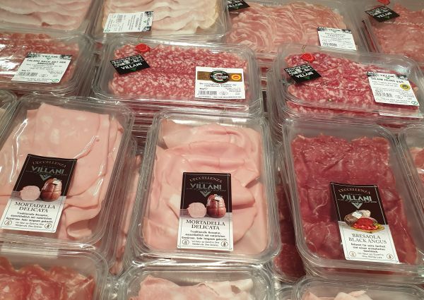 Di Gennaro's Italian deli: Packaged Villani mortadella, salami, and bresaola meats on display for international buyers at Anuga.