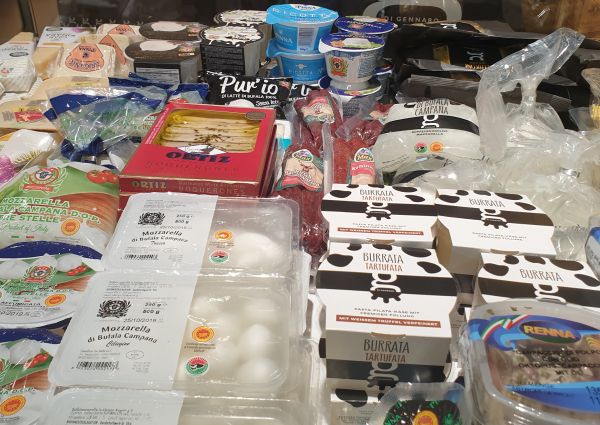 Italian deli display at Anuga: Burrata, mozzarella, ricotta, and Ortiz boquerones. Di Gennaro's Italian food selection.