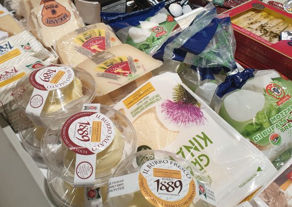Italian deli display at Anuga featuring Di Gennaro's cheeses, including burrata, mozzarella, and aged varieties.