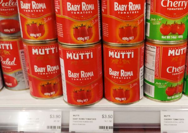 Eataly Chicago: Mutti brand canned tomatoes. Baby Roma and cherry tomatoes on a shelf with price tags.