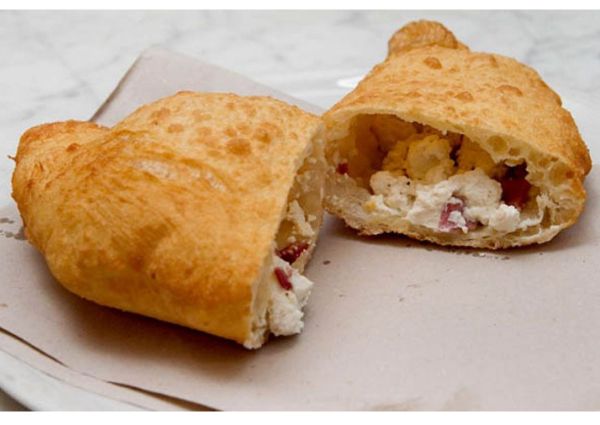 Halved Neapolitan fried pizza. Golden crust, ricotta cheese, and meat filling. Italian street food.