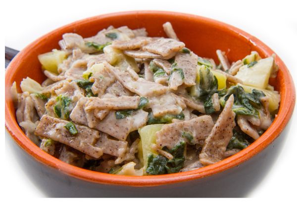 Pizzoccheri pasta bowl. Traditional Italian dish with buckwheat pasta, potatoes, and greens.