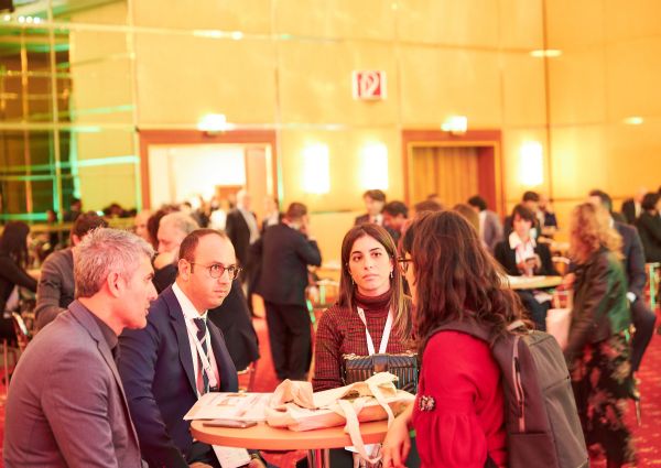Attendees at the Italian Food Awards 2019 event. People networking at a table.