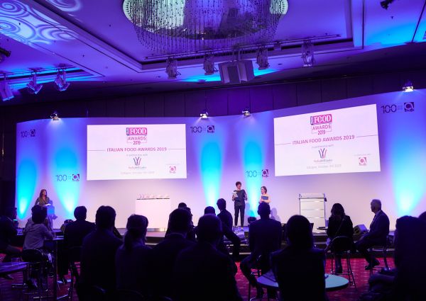 Italian Food Awards 2019 ceremony. Stage with presenters and audience. Food industry event.
