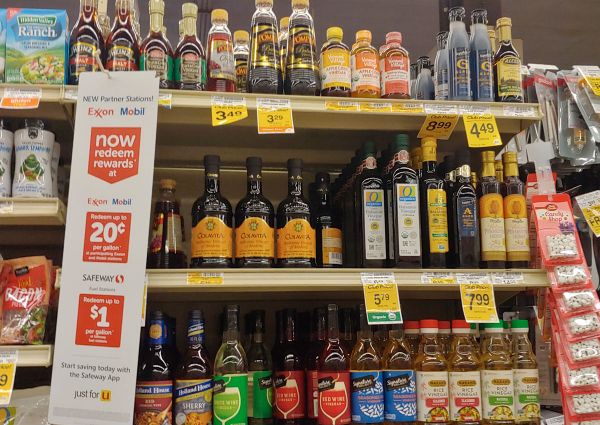 Safeway grocery aisle with natural quality dressings, vinegars, and oils. Wide selection of salad dressings and natural vinegars.
