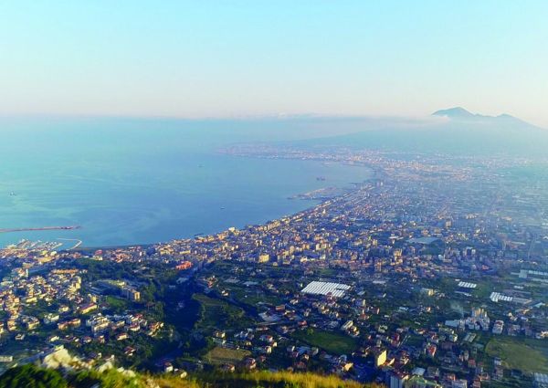 Aerial view of Gragnano, Italy, the city of pasta, with Mount Vesuvius in the distance and the sea.
