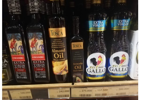 Spanish olive oils, almond oil, and avocado oil on shelves at 99 Ranch Market in Jakarta. Cooking oils.