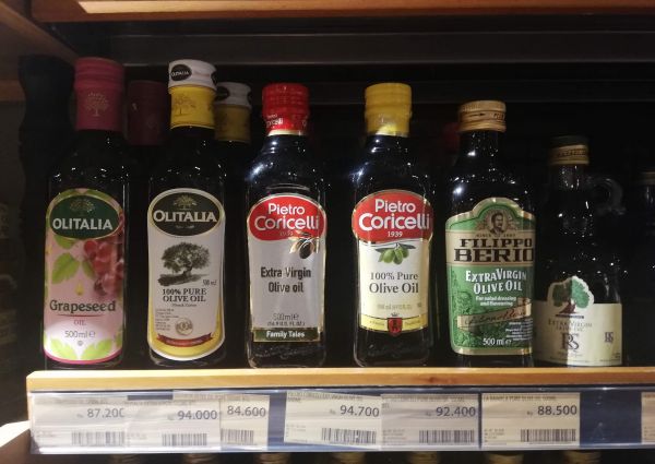 Olive oils by Pietro Coricelli, Olitalia, and Filippo Berio on a shelf at 99 Ranch Market in Jakarta.