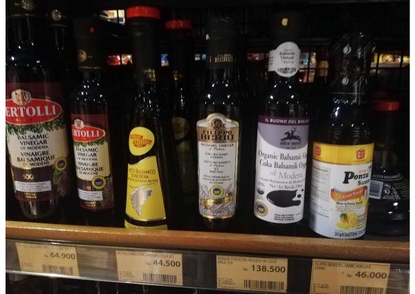 Balsamic vinegar selection. Alce Nero organic balsamic vinegar, Bertolli, and Filippo Berio brands on a shelf at 99 Ranch Market.