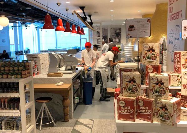 Rossopomodoro Eataly Canada. Italian food market with pizza chefs and Muzzi Tommaso panettone boxes.