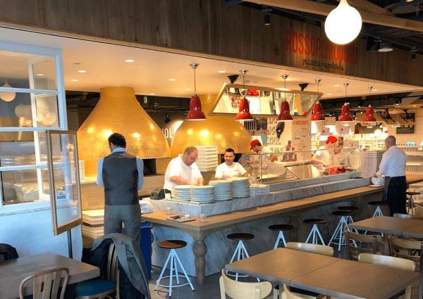 Rossopomodoro Pizzeria in Canada. Interior view of the restaurant with pizza chefs and wood-fired ovens.