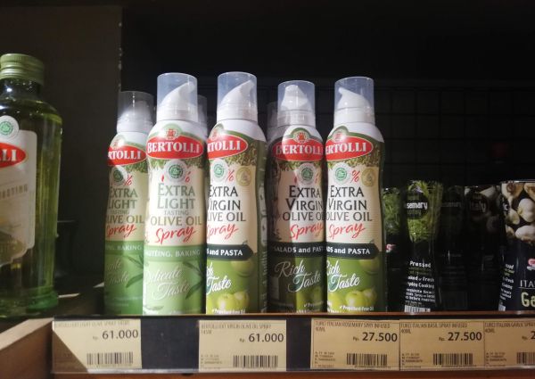 Bertolli olive oil spray cans on a shelf at 99 Ranch Market in Jakarta. Extra virgin and extra light olive oil.