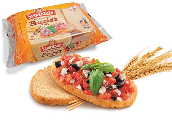 Semenzato bruschetta bread with tomatoes, olives, and basil. Package of bruschette bread. Italian appetizer.