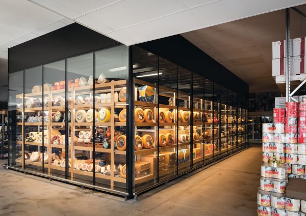 Italian cheese cathedral in Australia. Shelves of gourmet cheeses in a glass-enclosed display. European foods.