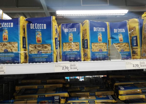 De Cecco pasta on a shelf at Coop Suisse. Italian food, pasta shapes, grocery shopping.