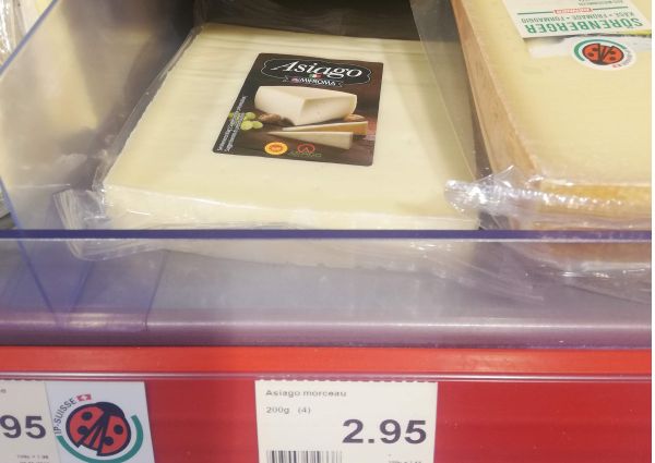 Mifroma Asiago PDO cheese on a shelf in a Denner Market in Switzerland.