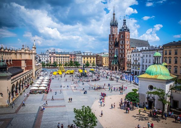 Krakow, Poland's Main Market Square. St. Mary's Basilica and Cloth Hall are visible. Italian food opportunities in Poland.