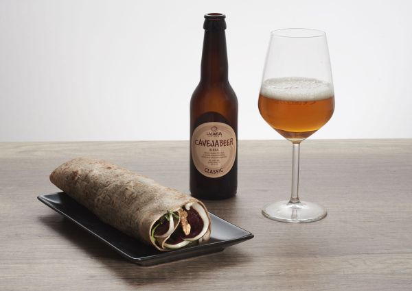 La Caveja beer with wrap. Romagna soul, world mind. Classic beer bottle and glass.