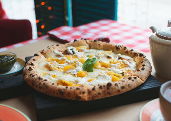 Neapolitan pizza with yellow tomatoes and basil. Authentic Italian pizza.