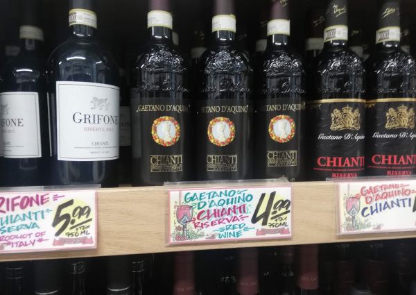 Trader Joe's Italian food: Chianti wine bottles on a shelf. Gaetano D'Aquino and Grifone Riserva.