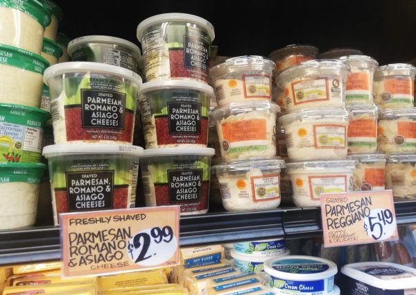 Trader Joe's Italian food: Shelves of Parmesan, Romano, Asiago cheeses and Parmigiano Reggiano. Discover Italian cheese.