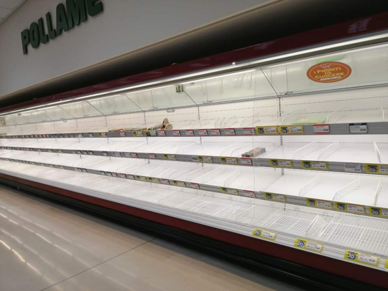 Empty supermarket shelves. Food shortage due to COVID-19 pandemic. Panic buying.