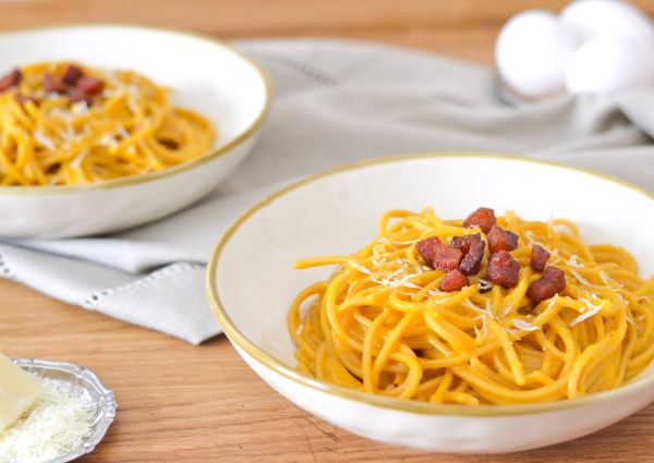 Two bowls of spaghetti carbonara with bacon and parmesan cheese. #CarbonaraDay