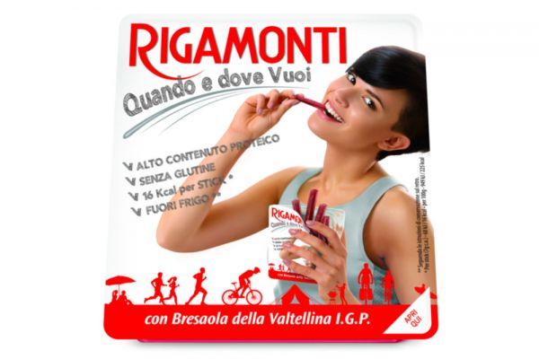Rigamonti Bresaola package. Woman eating pre-sliced charcuterie. Gluten-free, high protein snack. Italian cured meat.
