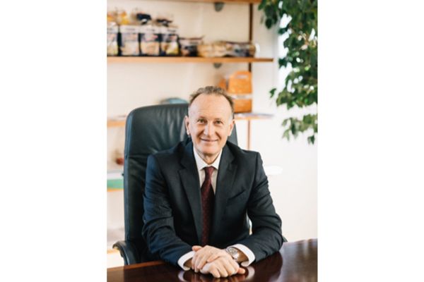 Stefano Maza of Morato Pane, Italian bakery. Man in suit sits at desk. Morato Pane is moving up in Italy and abroad.