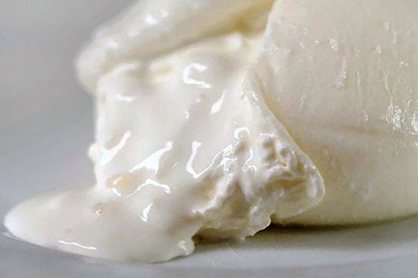 Close-up of creamy Burrata di Andria PGI, a specialty of Made in Italy, showcasing its soft, luscious texture.