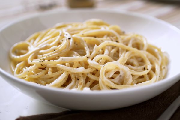 Creamy spaghetti with Biffi sauce in a white bowl. Delicious Italian pasta dish.
