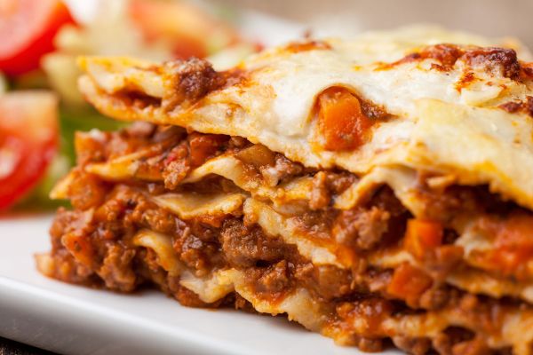 Close-up of a delicious, layered lasagna with meat sauce and cheese. Super Bowl food.