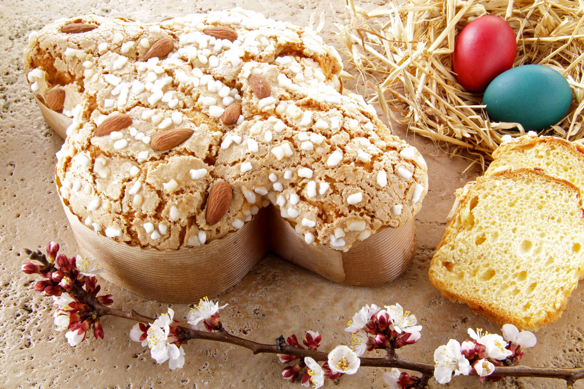 Colomba Pasquale with slice, typical italian easter cake with sugar glaze  and with almonds. Easter Dove in english. Isolated on white background  Stock Photo - Alamy