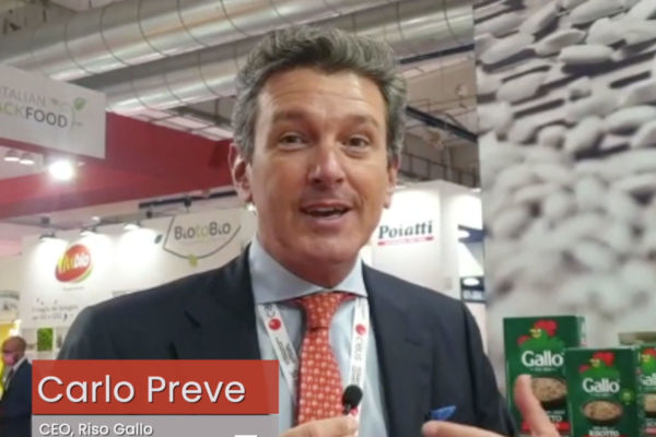 Carlo Preve, CEO of Riso Gallo, at the Cibus trade show promoting traditional Italian risotto. Riso Gallo risotto boxes visible.
