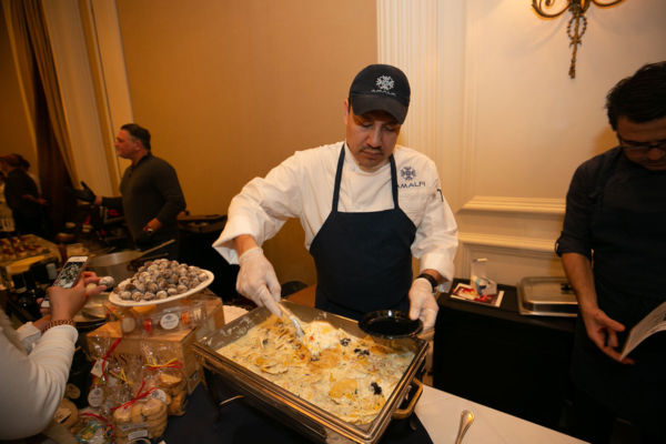 Taste of Italy Houston: Chef serving pasta at Italian food event. Amalfi restaurant.