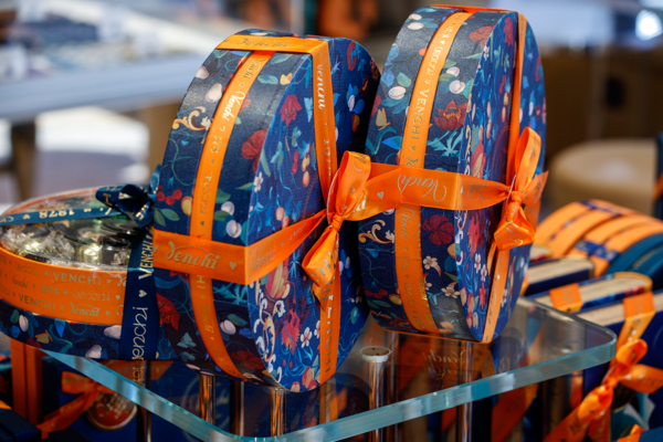 Venchi chocolate gift boxes. Floral design, orange ribbon. US retail sales up.
