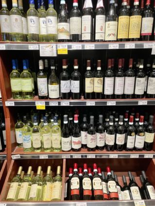 San Francisco Bay Area Italian food: Shelves stocked with red and white wine bottles.